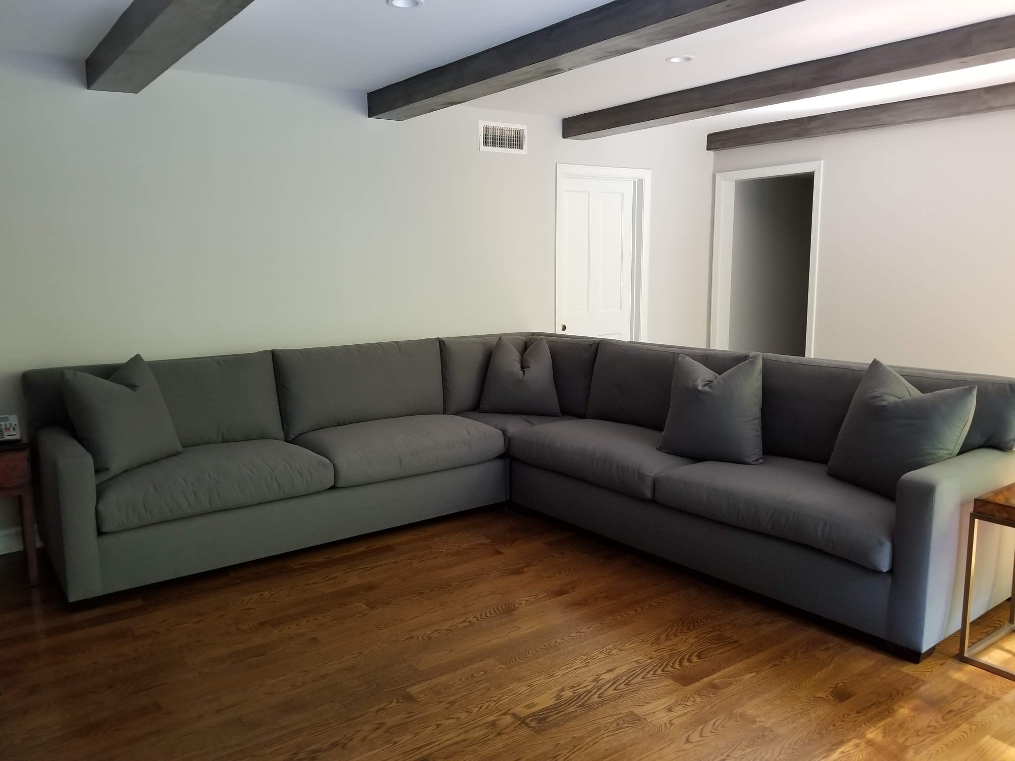 Sleep Furniture - Gray upholstered sofas in a living room with wooden flooring