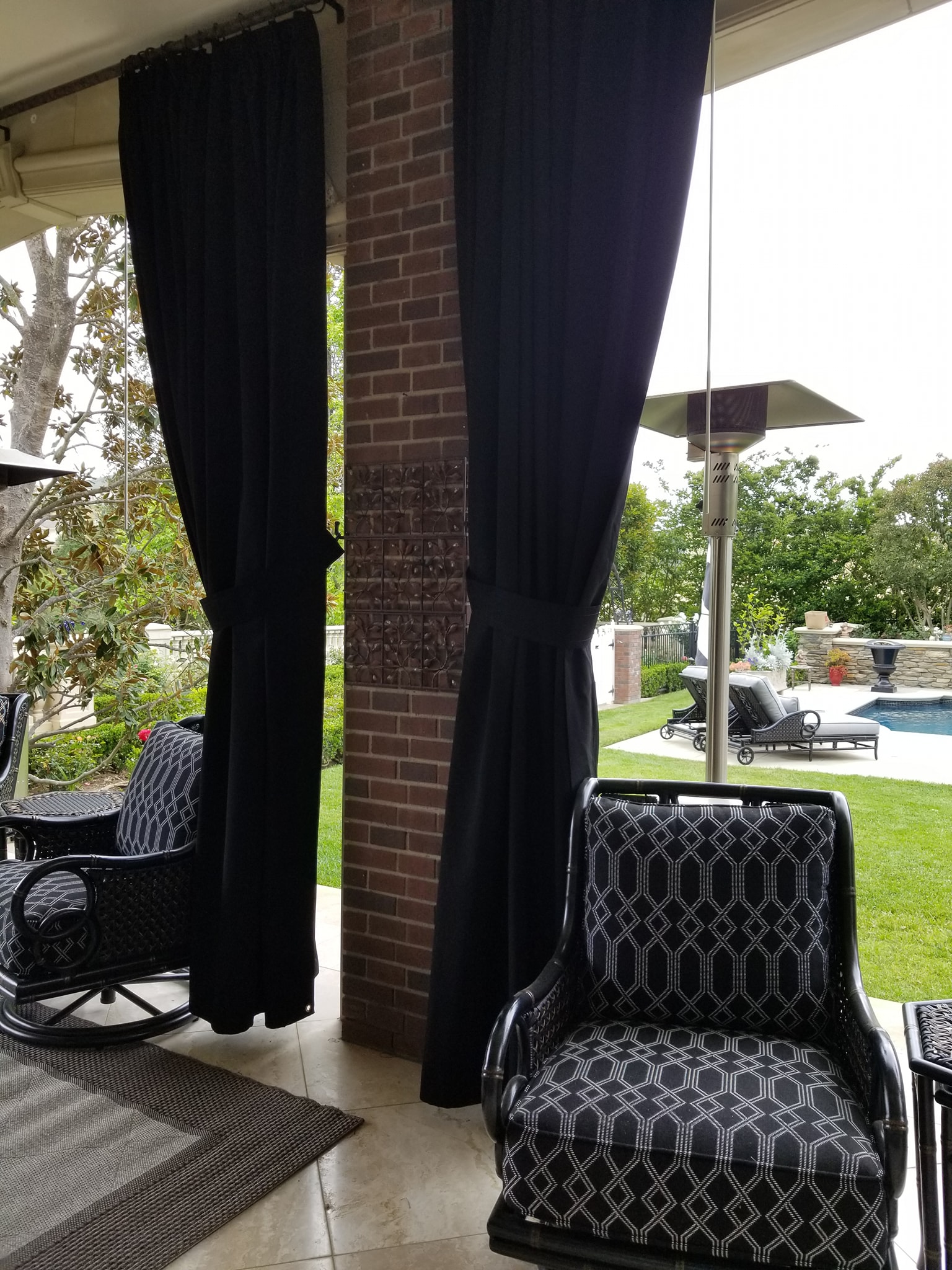 Canopy and Curtains - Outdoor black drapery and patio chairs