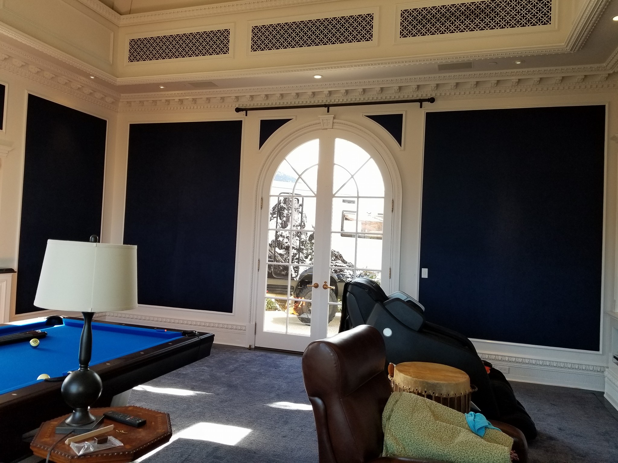 Hotels and Restaurant Service - Interior room with dark upholstered walls and arched glass door